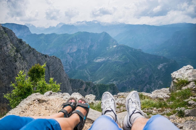 Loving couple resting on the top of the mountain after climbing