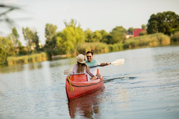 Loving couple rowing on the lake