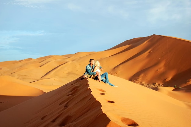 Loving couple in the Sahara Desert