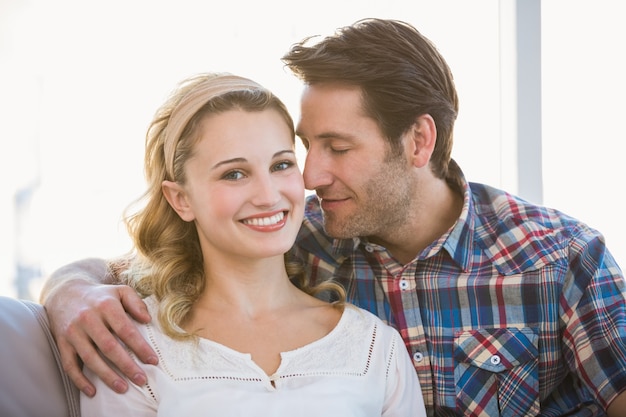 Photo loving couple sitting on couch