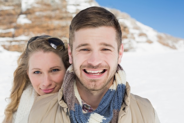 Loving couple on snow covered landscape