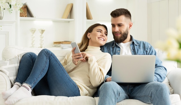 Loving Couple Spending Time Together Woman Showing Phone To Husband