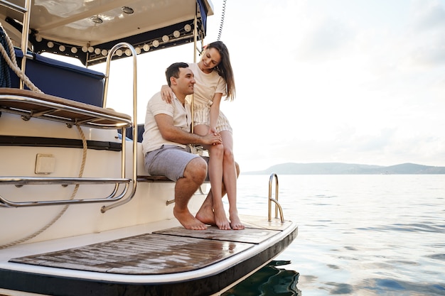 Loving couple spending time on a yacht at the sea