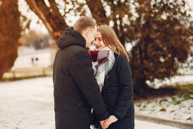 loving couple wallking in a snowy park