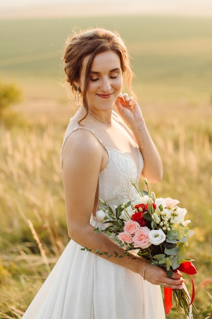 Loving couple wedding newlyweds outside at sunset in beautiful summer day