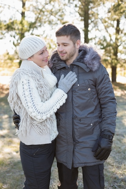 Loving couple in winter clothing in the woods