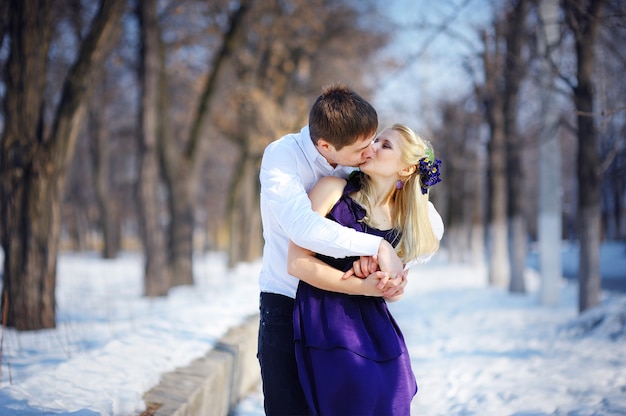 Loving couple in winter, kiss a guy and a girl