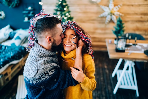 Photo loving couple with confetti on head before christmas