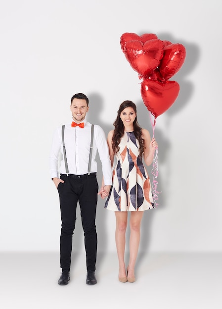 Loving couple with some red balloons