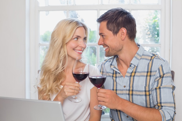 Loving couple with wine glasses looking at each other