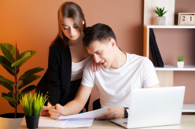 Loving couple working successfully together on their own business in the office