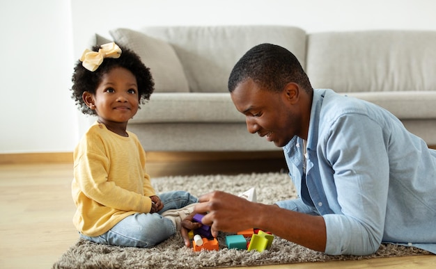 Loving dad enjoying making development activities with toddler child daughter