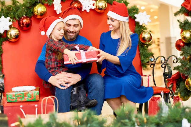 Loving family with gifts in shopping mall