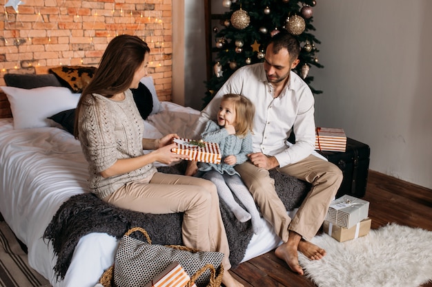 Loving family with presents in room