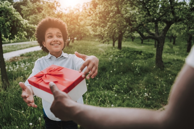 Loving Father Gives Gift and Boy Accepts it.