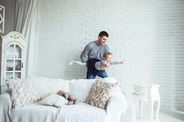 Loving father plays with his baby daughter