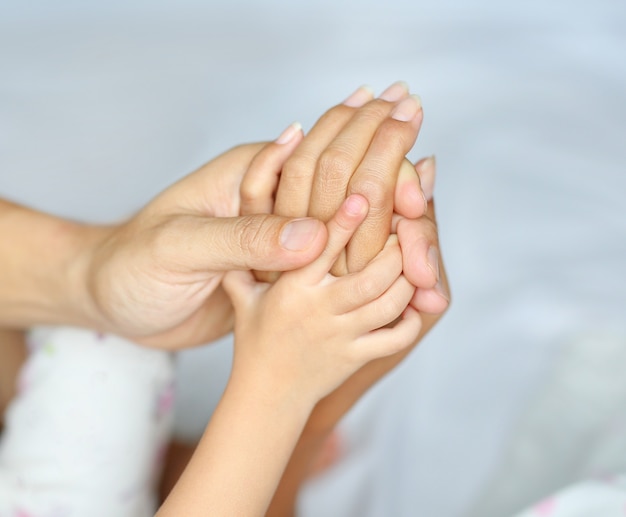 Loving hands clasped of Family father, mother and daughter.