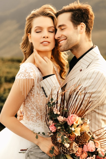 Loving happy couple hugging tenderly in beautiful clothes, romantic relationship.