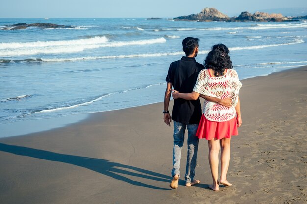 Loving happy couple walking along the beach. Romantic vacation happy honeymoon