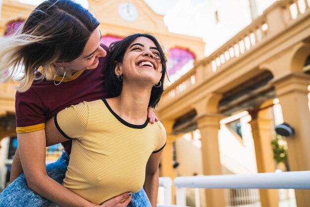 Loving lesbian couple having fun at the street