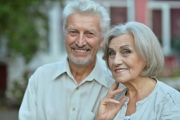 Loving mature couple  near house at summer