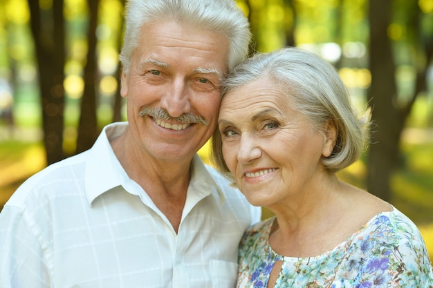 Loving mature couple  in summer park on the Sunset