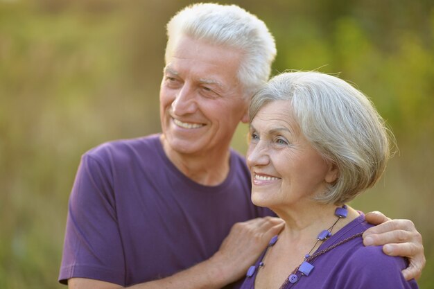 Loving mature couple  in summer park on the Sunset