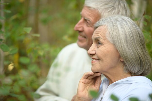 Photo loving mature couple  in a summer park