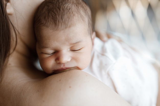 loving mom carying of her newborn baby at home