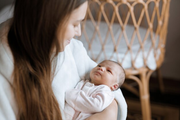 loving mom carying of her newborn baby at home