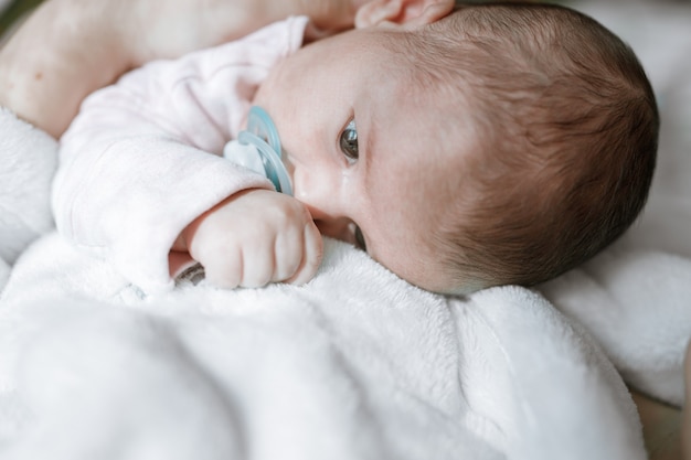 Loving mom carying of her newborn baby at home