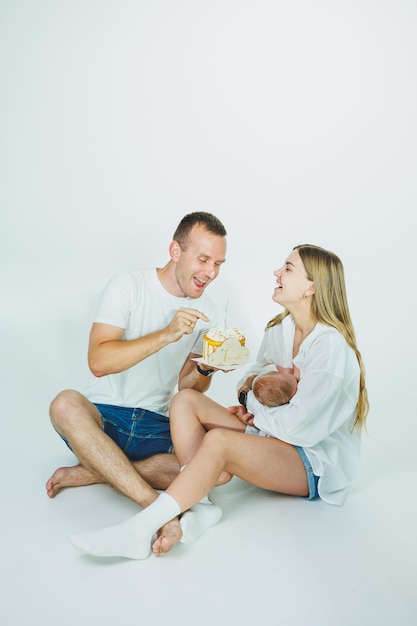 Loving mom and dad are holding a newborn baby in their arms Father and mother and his cute newborn son Parental relationship between parents and son Happy parenthood and the joy of being parents