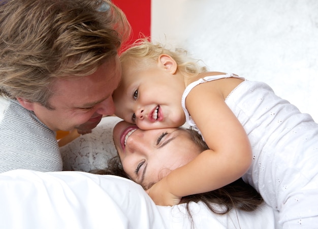 Loving mother and father smiling with young child