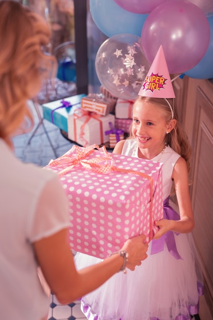 Loving mother giving birthday present to her child