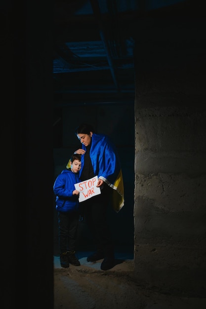 Loving mother holding her child in the bomb shelter The war in Ukraine Russia's aggression