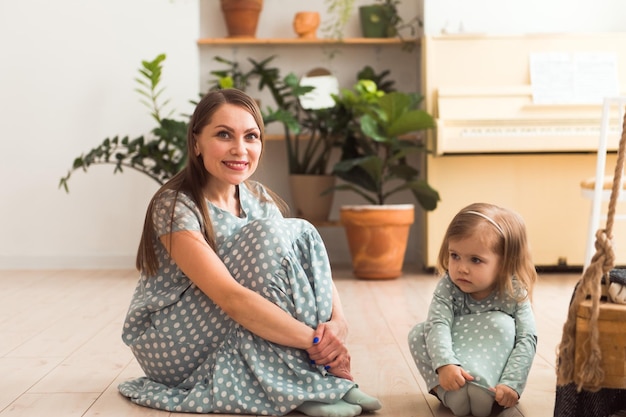 Loving mother playing cute daughter