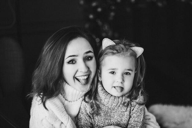 Loving mother with daughter in sweaters
