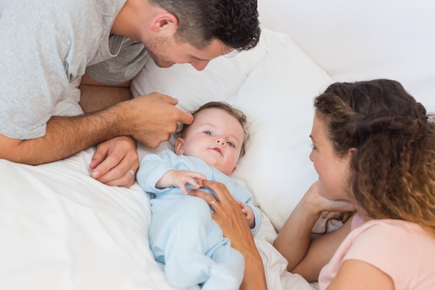 Loving parents playing with baby