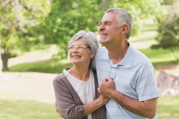 Loving senior couple holding hands at park