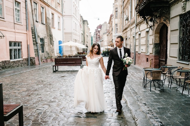 A loving wedding couple are walking along the streets of the city of Lviv. Newlyweds are walking. Wedding walks.