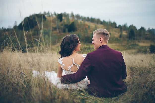 Loving wedding couple in the mountains