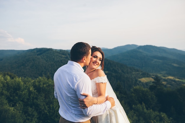 Loving wedding couple in the mountains