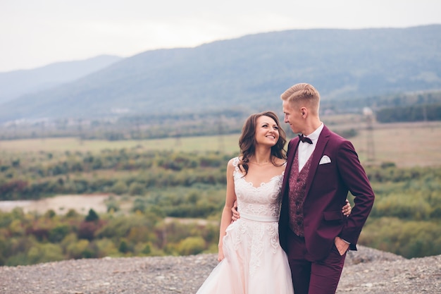 Loving wedding couple in the mountains