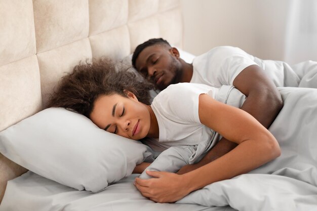 Loving young black couple having cozy morning cuddling in sleep