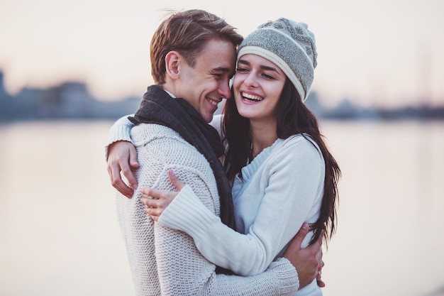 Loving young couple walk on the beach in autumn