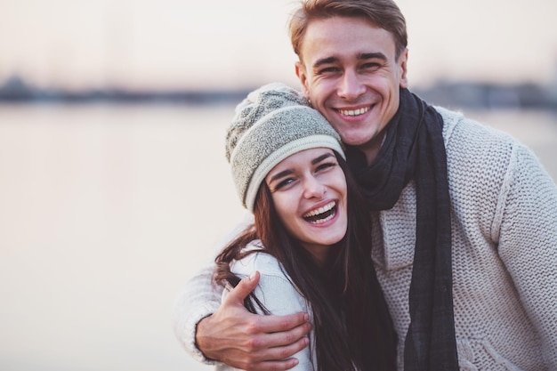 Loving young couple walk on the beach in autumn