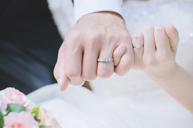 Loving Young love married couple holding hands and stand together