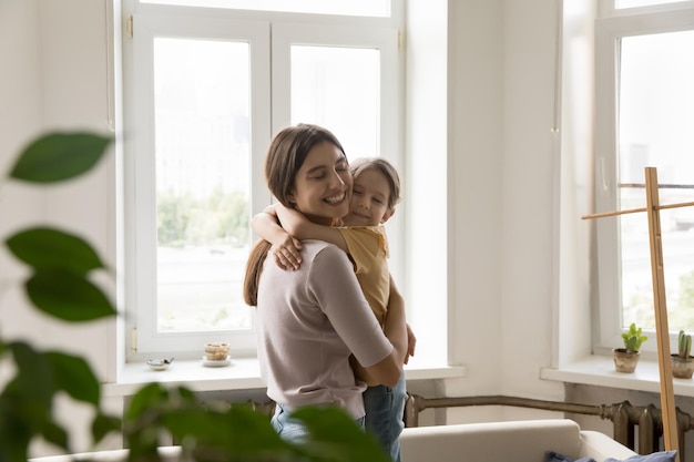 loving young mother hug cute little daughter