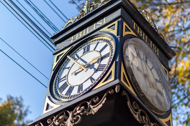 Low angle closeup shot of street clock in tbilisi city georgia