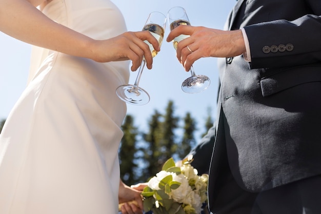 Low angle married couple holding drinks